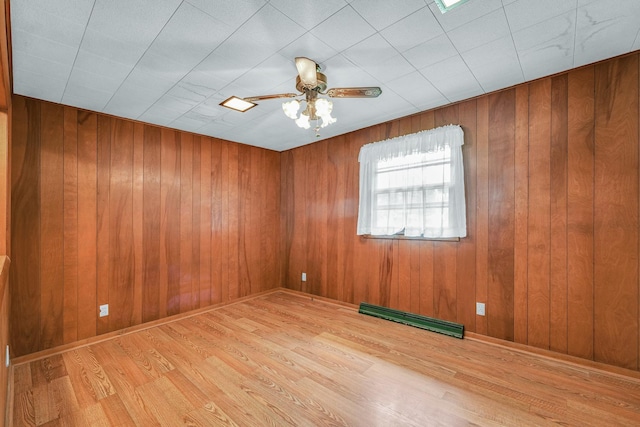 319 N Third St, Fisher, IL 61843 - unfurnished room with wood finished floors, ceiling fan, and wooden walls