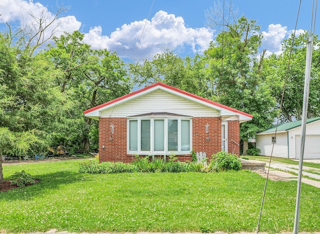 319 N Third St, Fisher, IL 61843 - view of front of home featuring brick siding, a front yard, and a garage