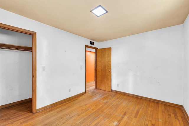 319 N Third St, Fisher, IL 61843 - unfurnished bedroom featuring light wood-type flooring and a closet