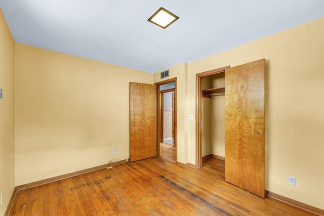 319 N Third St, Fisher, IL 61843 - unfurnished bedroom with hardwood / wood-style flooring and a closet