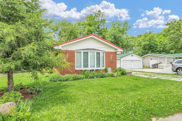 319 N Third St, Fisher, IL 61843 - view of front of property featuring brick siding, an outdoor structure, a detached garage, and a front yard