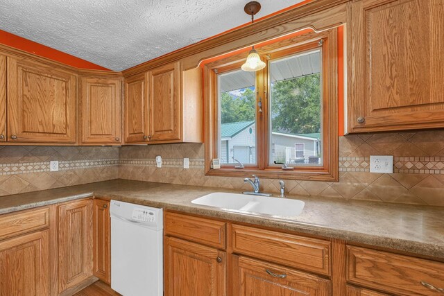 319 N Third St, Fisher, IL 61843 - kitchen featuring white dishwasher, brown cabinets, hanging light fixtures, and a textured ceiling