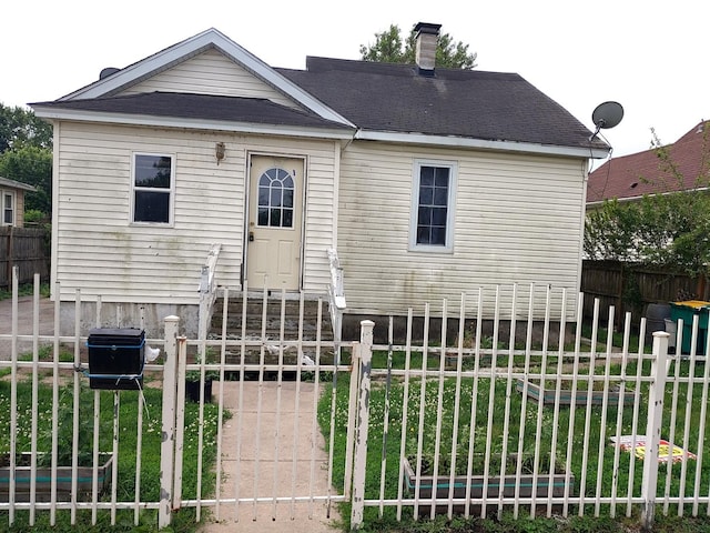 view of front facade featuring entry steps and a chimney