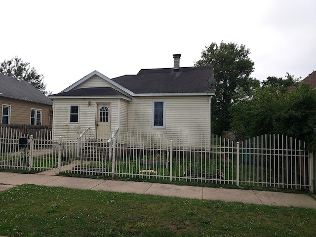 view of front of home featuring a fenced front yard and a chimney