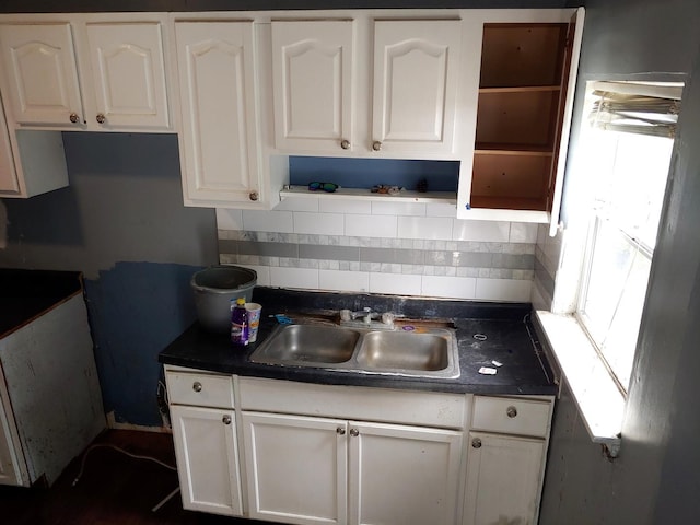 kitchen with open shelves, white cabinetry, decorative backsplash, and dark countertops