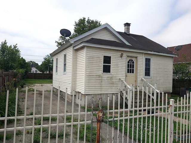 view of front of house with a chimney and entry steps