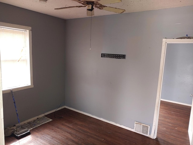 empty room with ceiling fan and wood finished floors