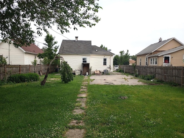 rear view of house featuring a patio and a fenced backyard
