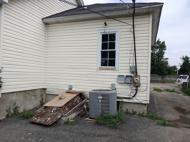 view of side of home with a central AC unit