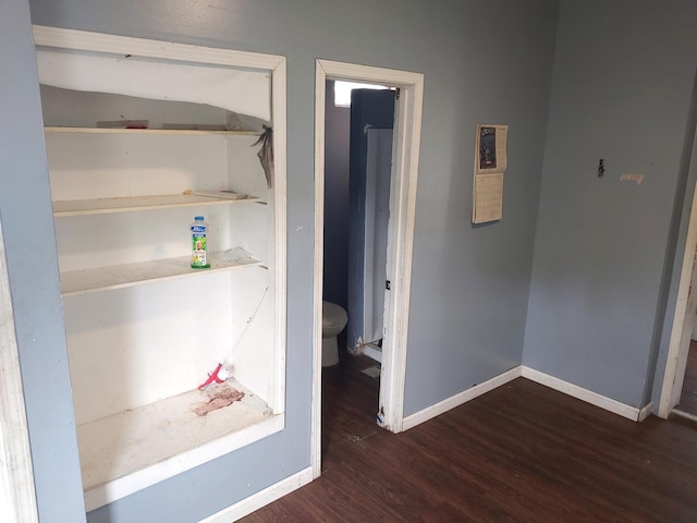 interior space featuring wood finished floors and baseboards