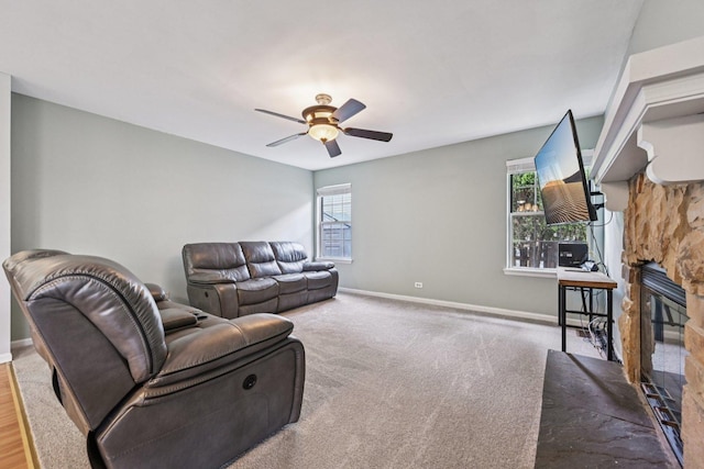 1643 Warrington Ln, Crystal Lake, IL 60014 - living room with healthy amount of natural light, a ceiling fan, a stone fireplace, and carpet floors