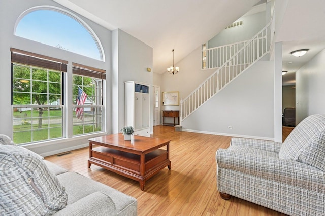 1643 Warrington Ln, Crystal Lake, IL 60014 - living area with stairway, high vaulted ceiling, wood finished floors, and a chandelier