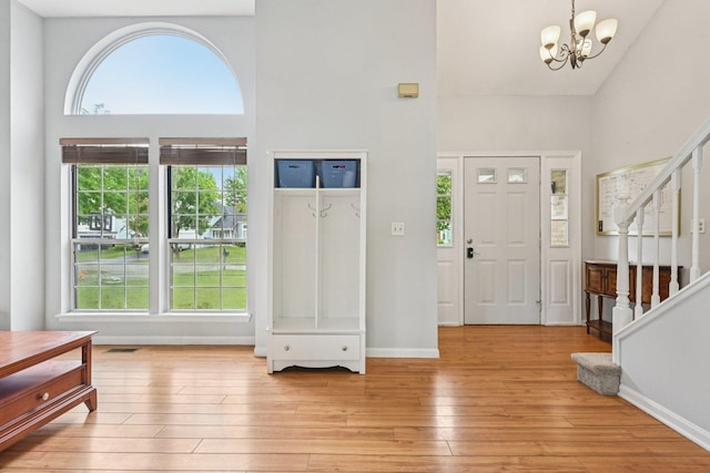 1643 Warrington Ln, Crystal Lake, IL 60014 - entrance foyer with stairs, healthy amount of natural light, a towering ceiling, light wood-style floors, and a chandelier