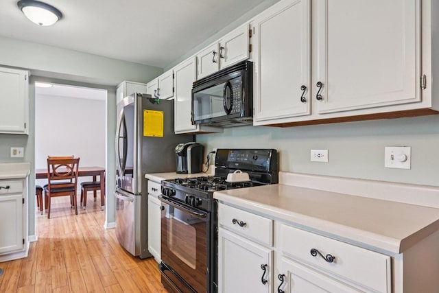 1643 Warrington Ln, Crystal Lake, IL 60014 - kitchen featuring black appliances, light countertops, white cabinets, and light wood-style floors