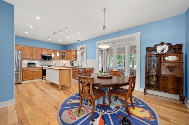 1639 Brower Pl, Sycamore, IL 60178 - dining area with light wood finished floors, rail lighting, and french doors