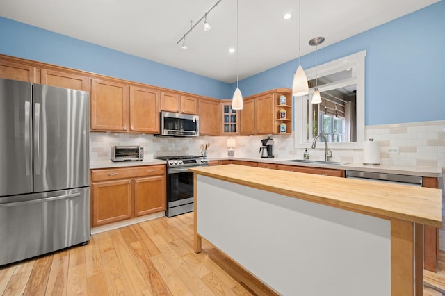 1639 Brower Pl, Sycamore, IL 60178 - kitchen with stainless steel appliances, butcher block countertops, light wood-type flooring, backsplash, and decorative light fixtures