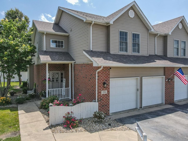 236 Marquette Pl S, Manteno, IL 60950 - view of front of house with an attached garage, brick siding, a shingled roof, and driveway