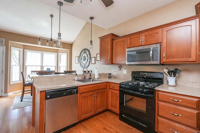 236 Marquette Pl S, Manteno, IL 60950 - kitchen featuring stainless steel appliances, a peninsula, brown cabinets, light countertops, and vaulted ceiling
