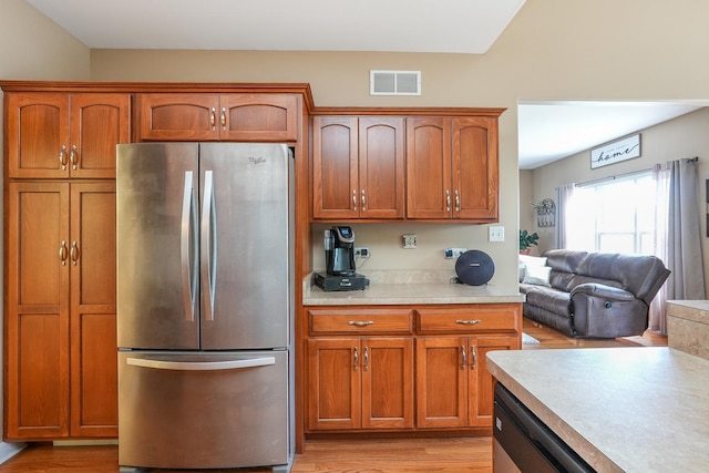 236 Marquette Pl S, Manteno, IL 60950 - kitchen featuring freestanding refrigerator, light countertops, brown cabinets, light wood finished floors, and open floor plan