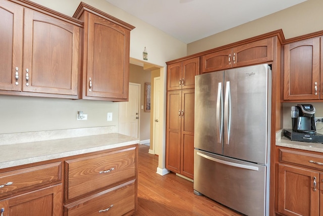 236 Marquette Pl S, Manteno, IL 60950 - kitchen featuring freestanding refrigerator, light countertops, light wood-style floors, and brown cabinets