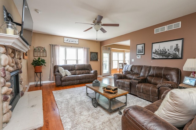 236 Marquette Pl S, Manteno, IL 60950 - living area with ceiling fan, wood finished floors, and a stone fireplace
