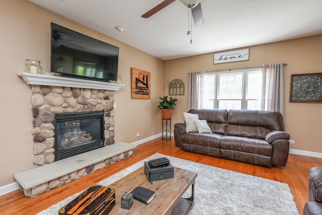236 Marquette Pl S, Manteno, IL 60950 - living room with a ceiling fan, a stone fireplace, and wood finished floors