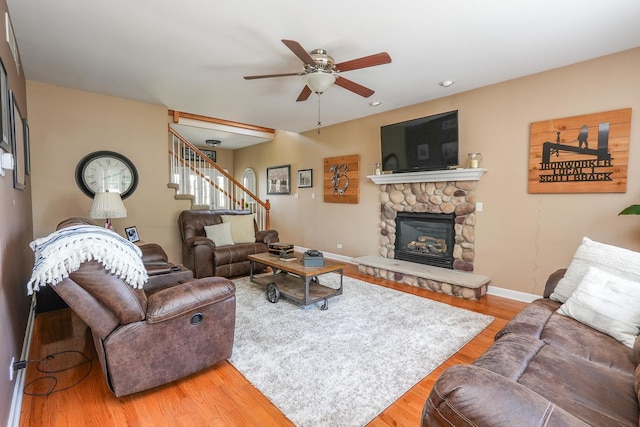 236 Marquette Pl S, Manteno, IL 60950 - living room featuring a ceiling fan, wood finished floors, a stone fireplace, stairway, and recessed lighting
