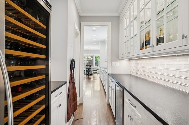 924 Linden Ave, Wilmette, IL 60091 - bar area with wine cooler, tasteful backsplash, wood finished floors, ornamental molding, and recessed lighting