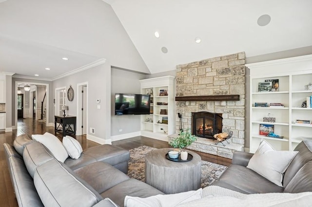 924 Linden Ave, Wilmette, IL 60091 - living room with dark wood-style flooring, a stone fireplace, ornamental molding, recessed lighting, and high vaulted ceiling