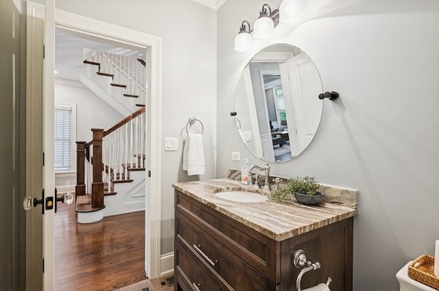 924 Linden Ave, Wilmette, IL 60091 - half bath featuring vanity, ornamental molding, and wood finished floors