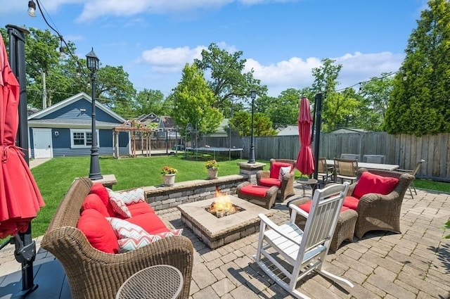 924 Linden Ave, Wilmette, IL 60091 - fenced backyard with a patio area, a trampoline, outdoor dining area, an outdoor living space with a fire pit, and an outbuilding