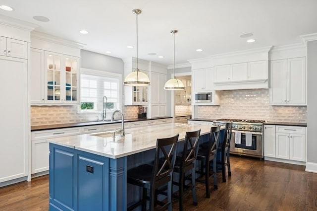 924 Linden Ave, Wilmette, IL 60091 - kitchen with stainless steel appliances, dark wood-type flooring, white cabinets, recessed lighting, and crown molding