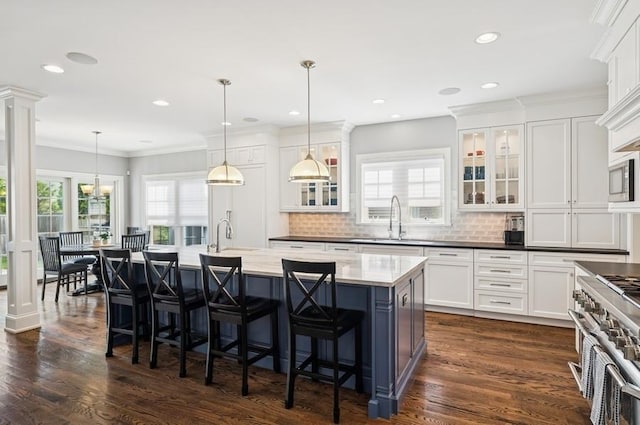 924 Linden Ave, Wilmette, IL 60091 - kitchen featuring stainless steel appliances, white cabinetry, decorative backsplash, a center island with sink, and recessed lighting