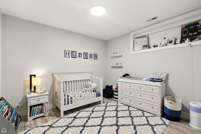 1437 W Grand Ave Unit 1S, Chicago, IL 60642 - bedroom with wood finished floors and a nursery area