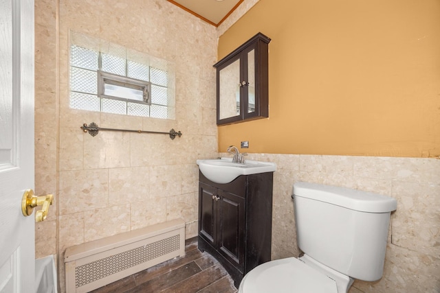 7647 S Calumet Ave, Chicago, IL 60619 - bathroom featuring tile walls, radiator, vanity, wainscoting, and crown molding
