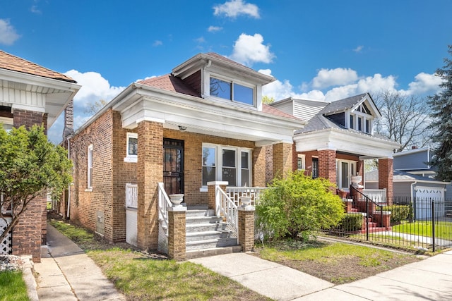 7647 S Calumet Ave, Chicago, IL 60619 - view of front facade with a porch, brick siding, and a shingled roof