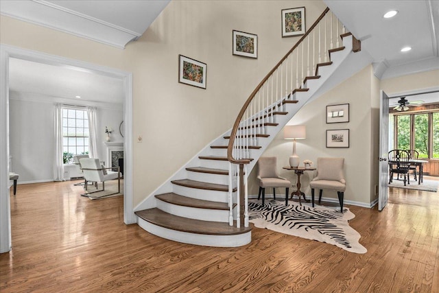 67 Brandon Rd, Northfield, IL 60093 - stairway with wood finished floors, healthy amount of natural light, ornamental molding, a fireplace, and recessed lighting