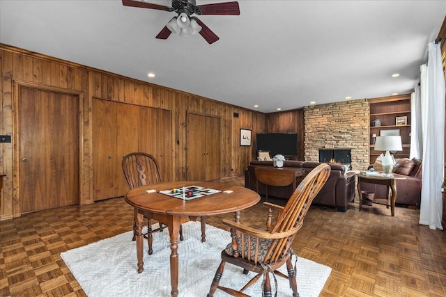 67 Brandon Rd, Northfield, IL 60093 - dining space featuring wooden walls, a ceiling fan, a stone fireplace, recessed lighting, and built in features