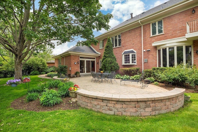67 Brandon Rd, Northfield, IL 60093 - rear view of house featuring a yard, a patio, and brick siding