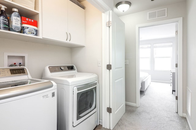 3551 Kemper Dr, Woodridge, IL 60517 - laundry room featuring cabinet space, separate washer and dryer, and light carpet