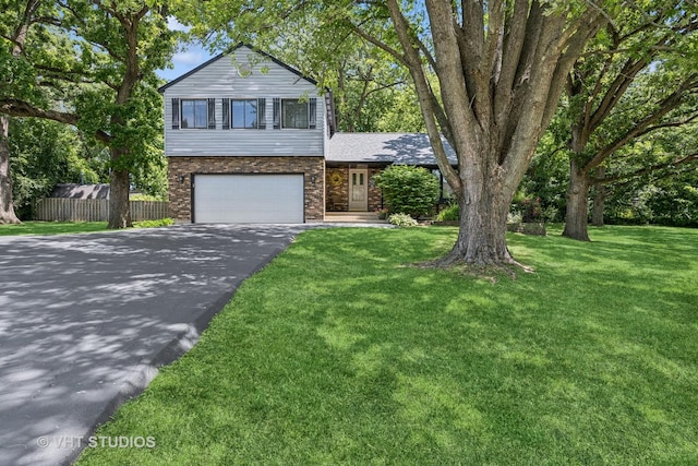 4816 Hickory Way, Johnsburg, IL 60051 - tri-level home featuring asphalt driveway, an attached garage, and brick siding