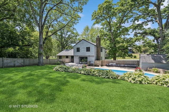 4816 Hickory Way, Johnsburg, IL 60051 - rear view of house with a chimney, a fenced backyard, and an outdoor structure