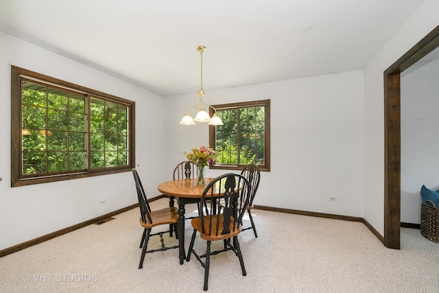4816 Hickory Way, Johnsburg, IL 60051 - dining space featuring plenty of natural light, a chandelier, and light carpet