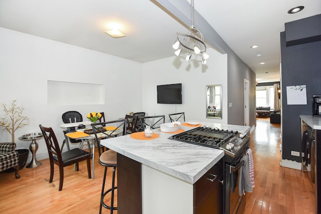 4220 S Champlain Ave Unit 2N, Chicago, IL 60653 - kitchen featuring gas stove, light countertops, a kitchen island, light wood finished floors, and recessed lighting