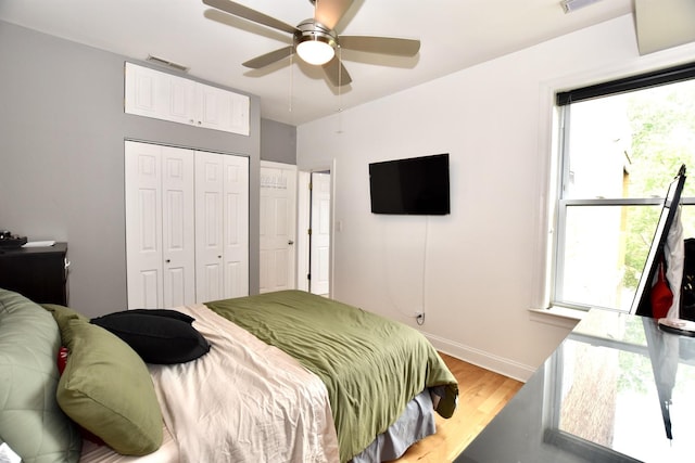 4220 S Champlain Ave Unit 2N, Chicago, IL 60653 - bedroom with light wood finished floors, a closet, and a ceiling fan