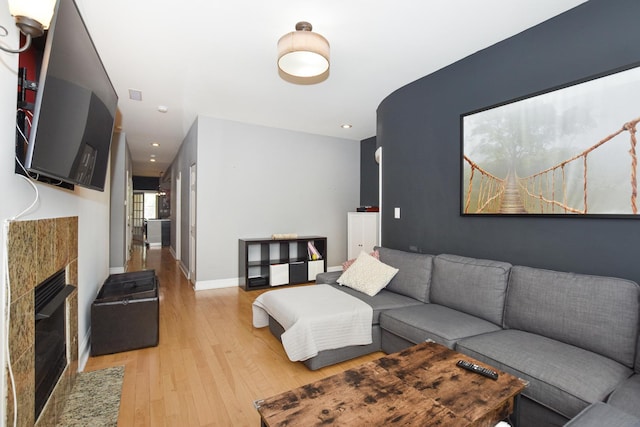 4220 S Champlain Ave Unit 2N, Chicago, IL 60653 - living room with light wood-style floors, a glass covered fireplace, and recessed lighting