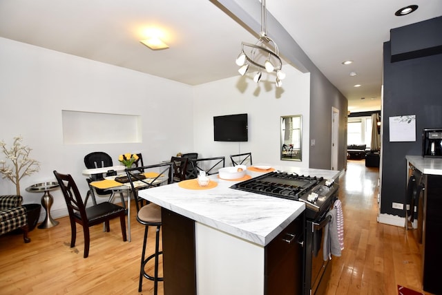 4220 S Champlain Ave Unit 2N, Chicago, IL 60653 - kitchen featuring gas range, a kitchen island, light countertops, light wood finished floors, and recessed lighting