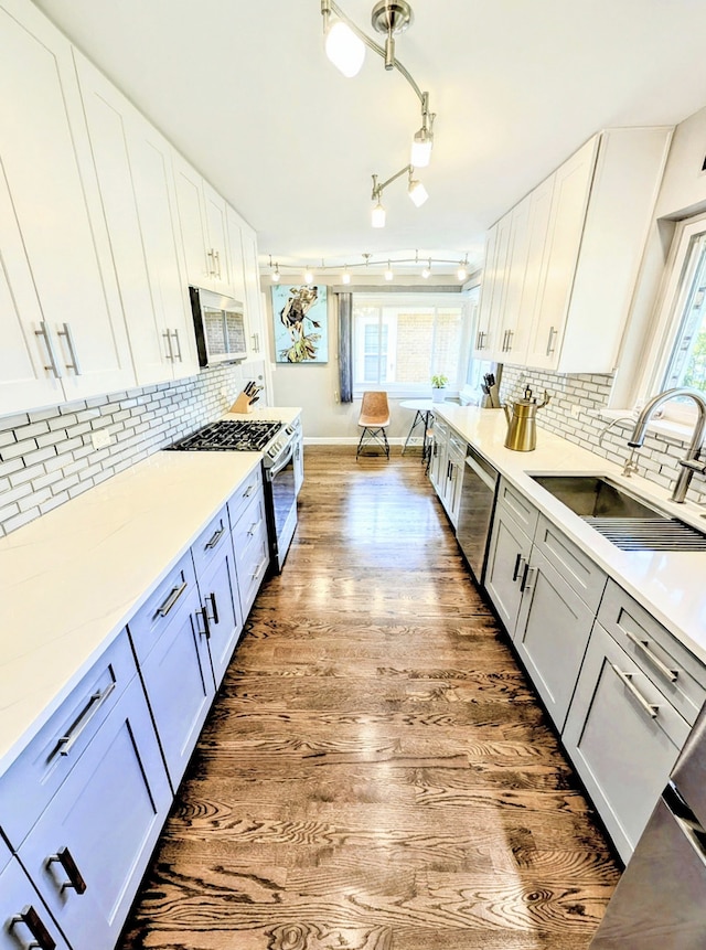 8049 Country Club Ln, North Riverside, IL 60546 - kitchen featuring appliances with stainless steel finishes, wood finished floors, healthy amount of natural light, and light countertops