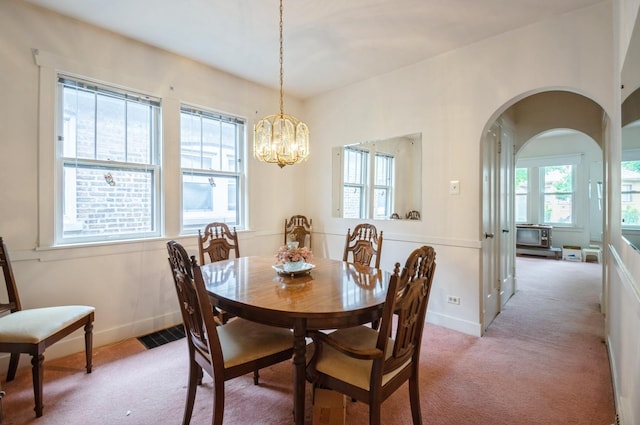 2931 N Lowell Ave, Chicago, IL 60641 - dining space with light colored carpet, a chandelier, and arched walkways