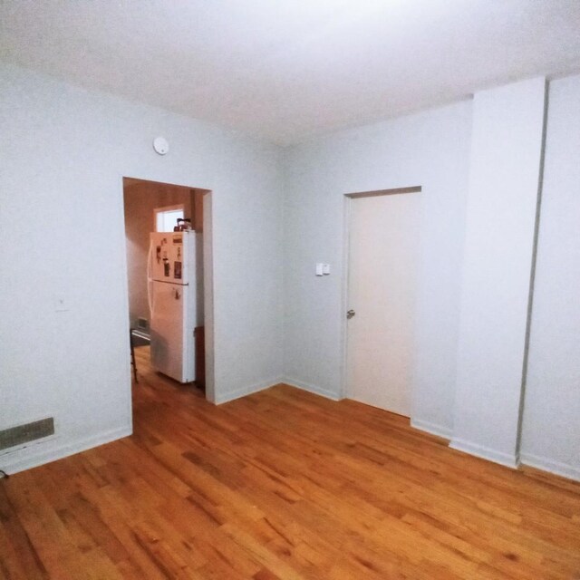 5443 S Long Ave, Chicago, IL 60638 - spare room with light wood-style flooring and a smoke detector